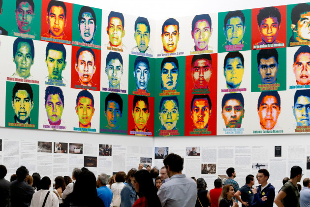 file-in-this-april-13-2019-file-photo-people-stand-under-the-portraits-of-43-disappeared-teachers-college-students-by-chinese-concept-artist-and-government-critic-ai-weiwei-at-the-contemporary-a