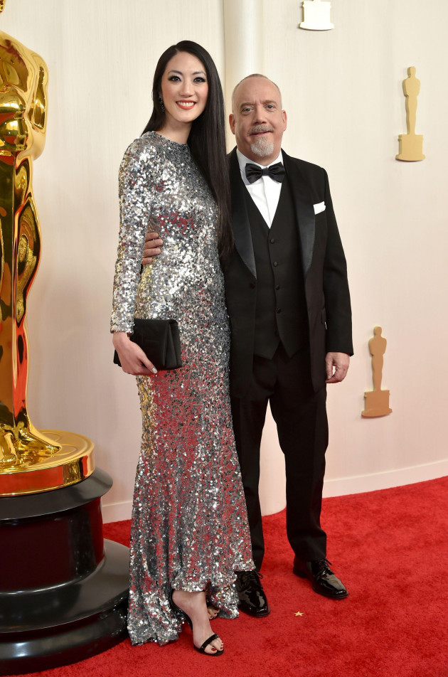 clara-wong-left-and-paul-giamatti-arrive-at-the-oscars-on-sunday-march-10-2024-at-the-dolby-theatre-in-los-angeles-photo-by-richard-shotwellinvisionap