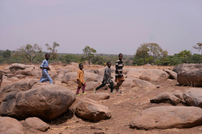 children-walk-past-the-bush-paths-that-the-abducted-schoolchildren-of-the-lea-primary-and-secondary-school-followed-in-kuriga-kaduna-nigeria-saturday-march-9-2024-the-kidnapping-on-thursday-was-o