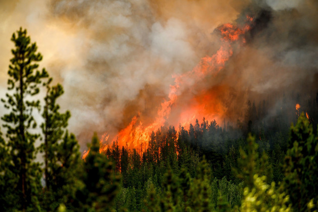 file-flames-from-the-donnie-creek-wildfire-burn-along-a-ridge-top-north-of-fort-st-john-british-columbia-on-july-2-2023-at-about-summers-halfway-point-the-record-breaking-heat-and-weather-ext