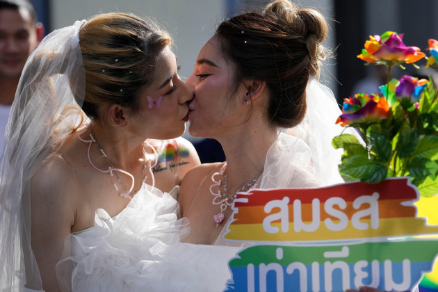 file-women-kiss-while-holding-a-poster-to-support-marriage-equality-during-a-pride-parade-in-bangkok-thailand-on-june-4-2023-thailands-cabinet-on-tuesday-nov-21-approved-an-amendment-to-its