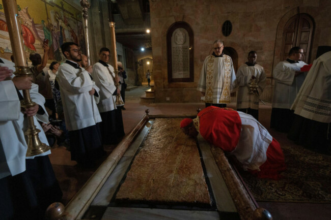 latin-patriarch-of-jerusalem-pierbattista-pizzaballa-kisses-the-stone-of-unction-which-is-traditionally-claimed-as-the-stone-where-jesus-body-was-prepared-for-burial-before-celebrating-the-easter-s