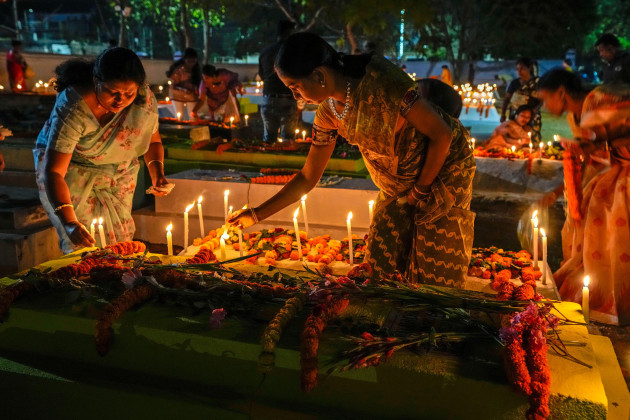 christian-families-remember-their-loved-ones-by-lighting-candles-and-putting-flowers-on-their-graves-early-morning-on-easter-in-purulia-west-bengal-india-sunday-march-31-2024-christian-around-th