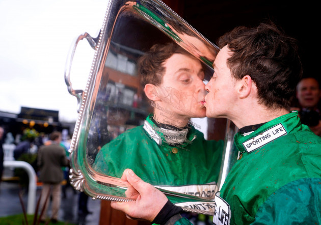 jockey-j-j-slevin-celebrates-with-the-trophy-after-winning-the-boylesports-irish-grand-national-chase-on-intense-raffles-during-the-fairyhouse-easter-festival-2024-at-fairyhouse-racecourse-in-county-m
