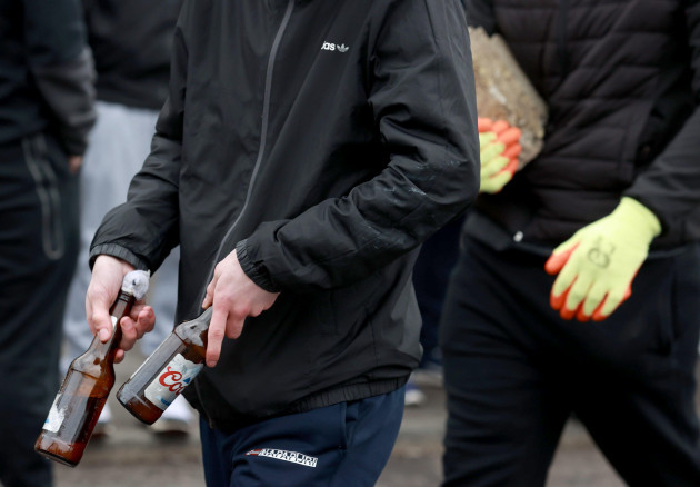a-group-of-young-men-carrying-petrol-bombs-and-stones-at-the-start-of-an-easter-monday-parade-in-the-creggan-area-of-londonderry-commemorating-the-anniversary-of-the-easter-rising-rebellion-of-1916