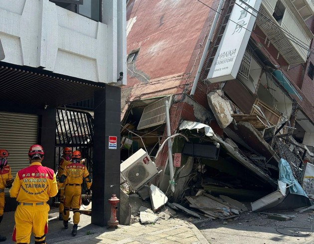 in-this-photo-released-by-the-national-fire-agency-members-of-a-search-and-rescue-team-prepare-outside-a-leaning-building-in-the-aftermath-of-an-earthquake-in-hualien-eastern-taiwan-on-wednesday-ap