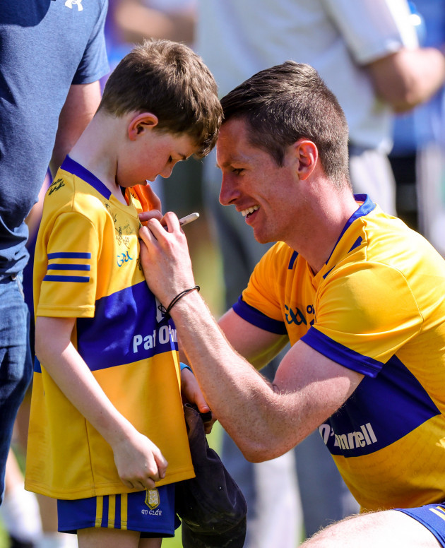 eoin-cleary-signs-a-young-supporters-jersey-after-the-game