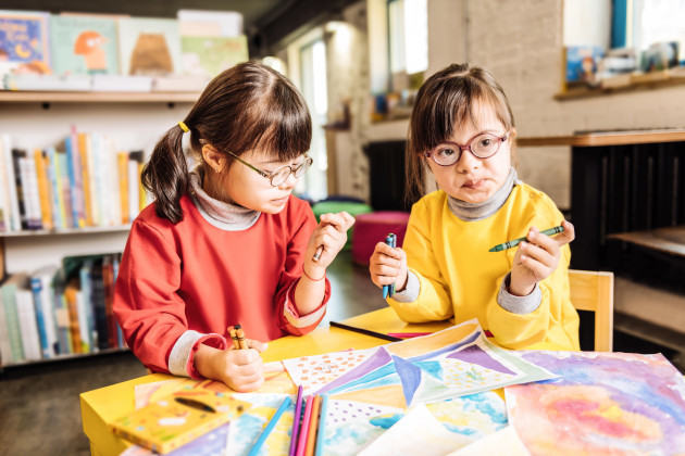 two-preschool-girls-playing-and-coloring-pictures-in-rehabilitation-center