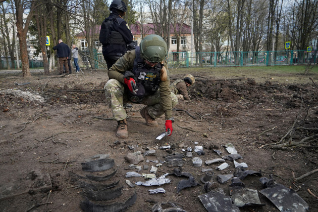 a-military-expert-examines-the-site-of-a-russian-bombing-that-killed-several-people-in-kharkiv-ukraine-saturday-april-6-2024-ap-photoandrii-marienko
