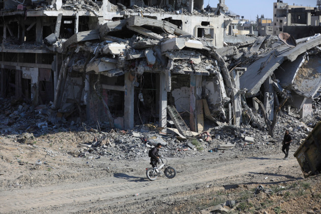 palestinians-walk-through-the-destruction-left-by-the-israeli-air-and-ground-offensive-after-they-withdrew-from-khan-younis-southern-gaza-strip-sunday-april-7-2024-ap-photoismael-abu-dayyah