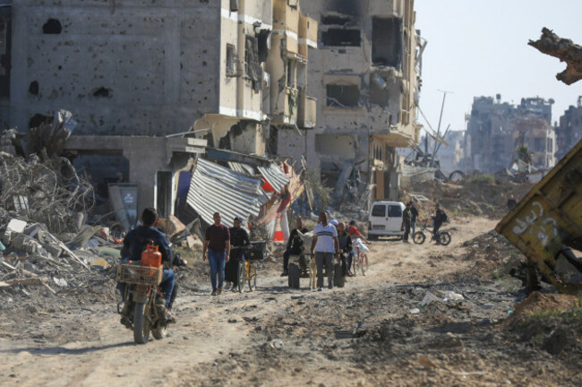 palestinians-walk-through-the-destruction-left-by-the-israeli-air-and-ground-offensive-after-they-withdrew-from-khan-younis-southern-gaza-strip-sunday-april-7-2024-ap-photoismael-abu-dayyah