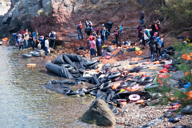syrian-and-afghani-refugees-disembark-from-rafts-in-a-cove-on-the-island-of-lesvos-greece-after-crossing-from-turkey-image-shot-092015-exact-date-unknown