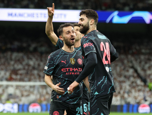madrid-spain-9th-apr-2024-joko-gvardiol-of-manchester-city-r-celebrates-with-bernardo-silva-of-manchester-city-after-scoring-his-teams-third-goal-during-the-uefa-champions-league-match-at-the-s