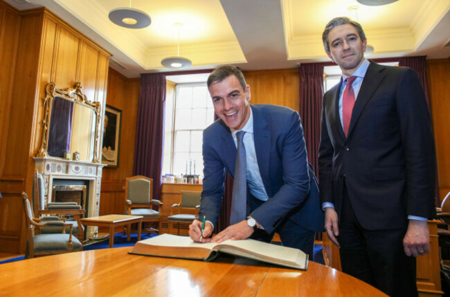 spanish-prime-minister-pedro-sanchez-left-signs-the-visitors-book-with-taoiseach-simon-harris-in-government-buildings-dublin-picture-date-friday-april-12-2024