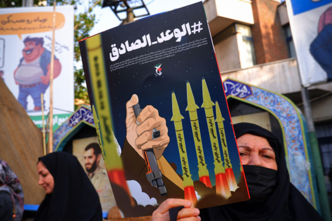 tehran-iran-14th-apr-2024-an-iranian-pro-government-supporter-woman-holds-an-anti-israel-poster-on-palestine-street-in-downtown-tehran-israel-on-sunday-hailed-its-air-defenses-in-the-face-of-an-u