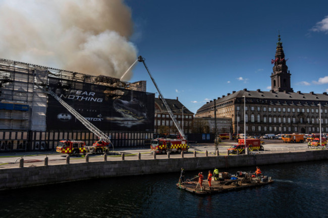 firefighters-work-as-smoke-rises-out-of-the-old-stock-exchange-in-copenhagen-denmark-tuesday-april-16-2024-a-fire-raged-through-one-of-copenhagens-oldest-buildings-on-tuesday-causing-the-collap