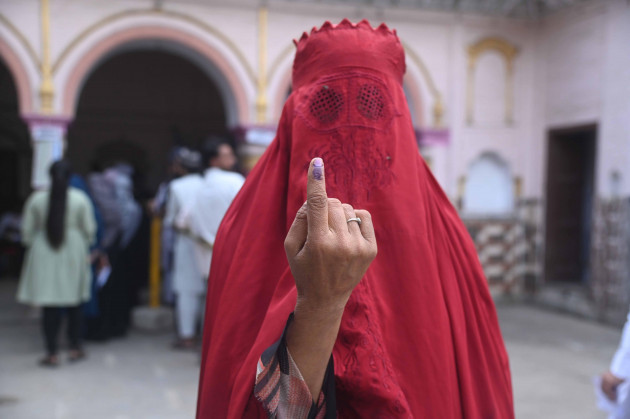 kairana-uttar-pradesh-india-19th-apr-2024-a-woman-clad-in-burqa-shows-her-inked-marked-finger-after-voting-at-a-polling-station-during-the-first-phase-of-general-election-at-kairana-in-the-north