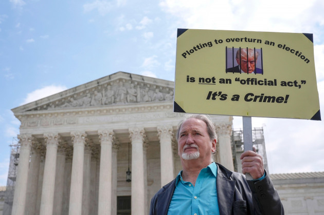 a-demonstrator-stands-outside-the-supreme-court-as-the-justices-prepare-to-hear-arguments-over-whether-donald-trump-is-immune-from-prosecution-in-a-case-charging-him-with-plotting-to-overturn-the-resu