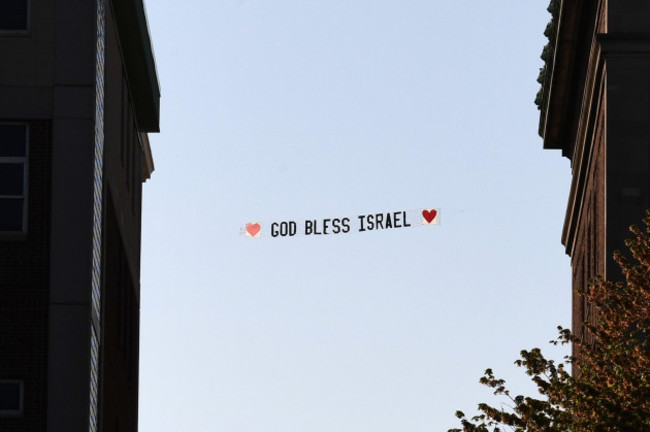new-york-usa-26th-apr-2024-a-banner-reading-god-bless-israel-being-pulled-behind-a-single-engine-plane-is-seen-between-campus-building-of-columbia-university-new-york-ny-april-26-2024-negot
