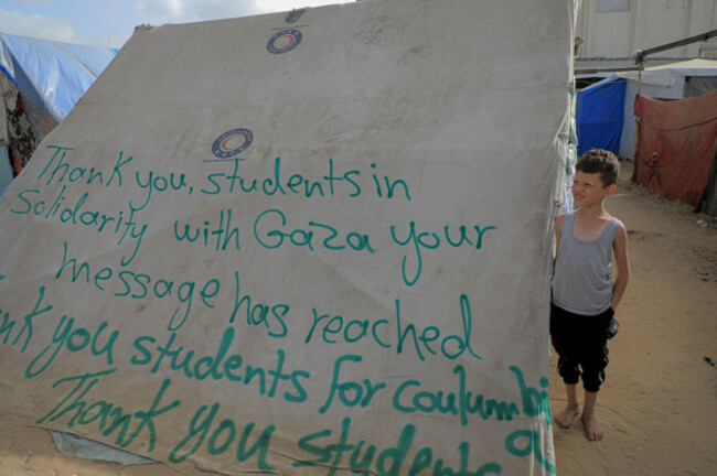 rafah-27th-apr-2024-a-boy-stands-next-to-a-tent-with-signs-of-gratitude-in-the-southern-gaza-strip-city-of-rafah-on-april-27-2024-pro-palestinian-demonstrations-are-spreading-on-campuses-across-t