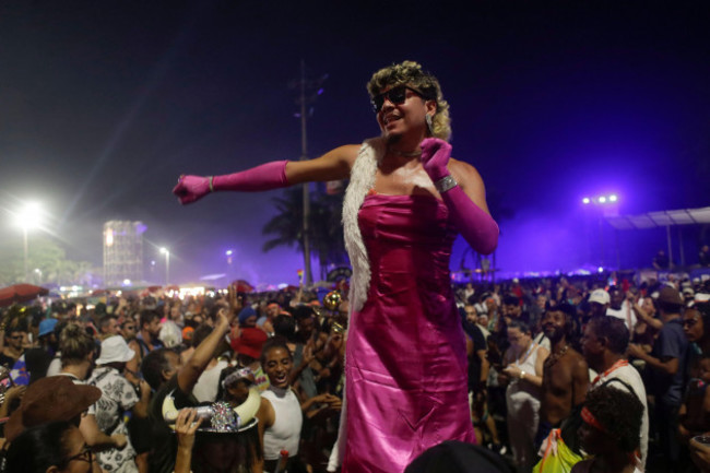 a-fan-dances-while-waiting-for-the-start-of-madonnas-last-show-of-her-the-celebration-tour-on-copacabana-beach-in-rio-de-janeiro-brazil-saturday-may-4-2024-ap-photobruna-prado