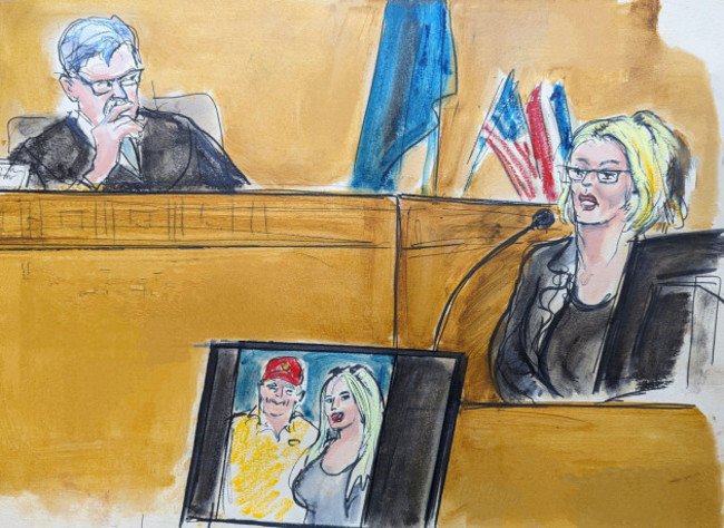 in-this-courtroom-sketch-stormy-daniels-testifies-on-the-witness-stand-as-judge-juan-merchan-looks-on-in-manhattan-criminal-court-tuesday-may-7-2024-in-new-york-a-photo-of-donald-trump-and-dani