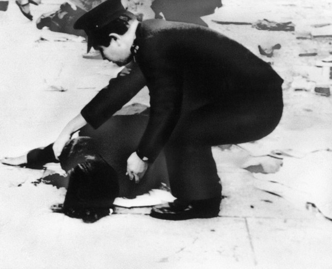 a-policeman-bends-over-body-of-a-victim-on-talbot-street-moments-after-a-car-bomb-exploded-in-dublin-may-18-1974-a-series-of-terrorist-car-bomb-attacks-in-the-city-claimed-the-lives-of-25-persons