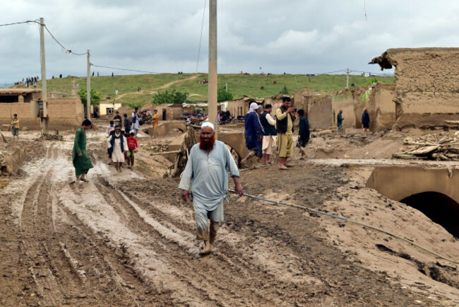 people-gather-around-their-damaged-houses-after-heavy-flooding-in-baghlan-province-in-northern-afghanistan-saturday-may-11-2024-flash-floods-from-seasonal-rains-in-baghlan-province-in-northern-afgh