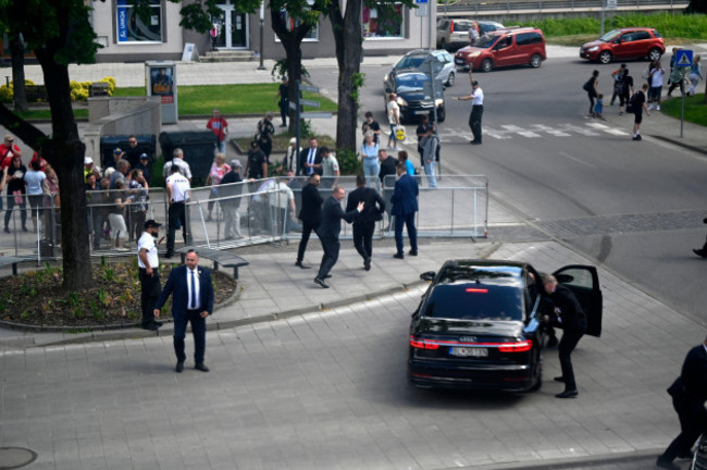 bodyguards-take-slovak-prime-minister-robert-fico-in-a-car-from-the-scene-after-he-was-shot-and-injured-following-the-cabinets-away-from-home-session-in-the-town-of-handlova-slovakia-wednesday-may