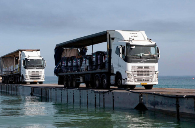 trucks-loaded-with-humanitarian-aid-from-the-united-arab-emirates-and-the-united-states-agency-for-international-development-cross-the-trident-pier-before-entering-the-beach-in-gaza-may-17-2024-st