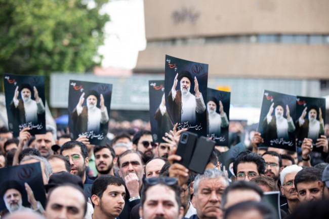 tehran-iran-20th-may-2024-iranian-people-hold-up-posters-of-iranian-president-ebrahim-raisi-during-a-mourning-ceremony-for-him-at-vali-e-asr-square-in-downtown-tehran-iran-monday-may-20-2024