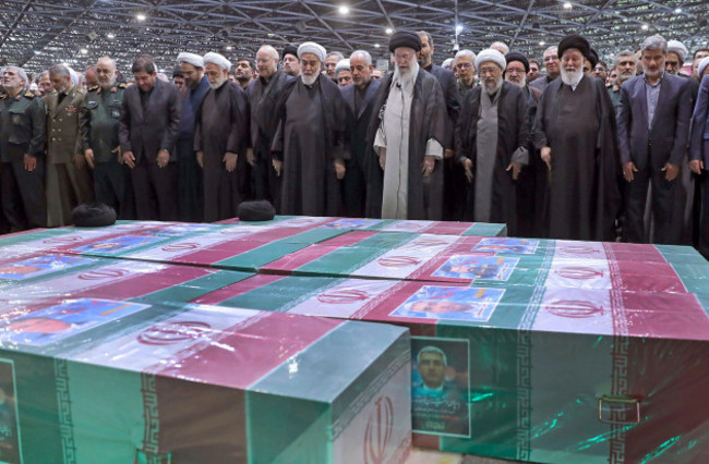 in-this-photo-released-by-the-office-of-the-iranian-supreme-leader-supreme-leader-ayatollah-ali-khamenei-center-right-with-black-turban-leads-a-prayer-over-the-flag-draped-coffins-of-the-late-presi