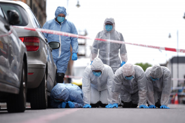 police-forensic-officers-in-dalston-east-london-near-to-the-scene-of-a-shooting-at-kingsland-high-street-hackney-east-london-where-three-adults-and-a-child-have-been-injured-the-metropolitan-pol