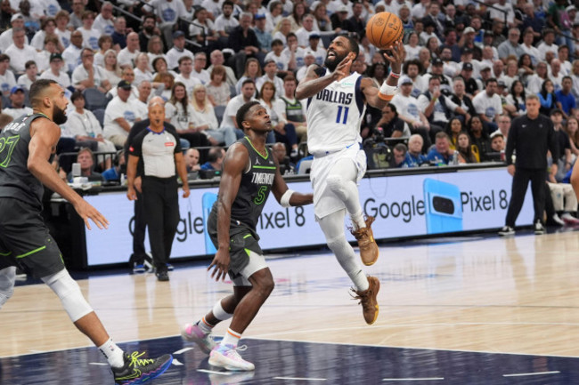 dallas-mavericks-guard-kyrie-irving-11-drives-past-minnesota-timberwolves-guard-anthony-edwards-5-as-timberwolves-center-rudy-gobert-left-looks-on-during-the-first-half-of-game-5-of-the-western