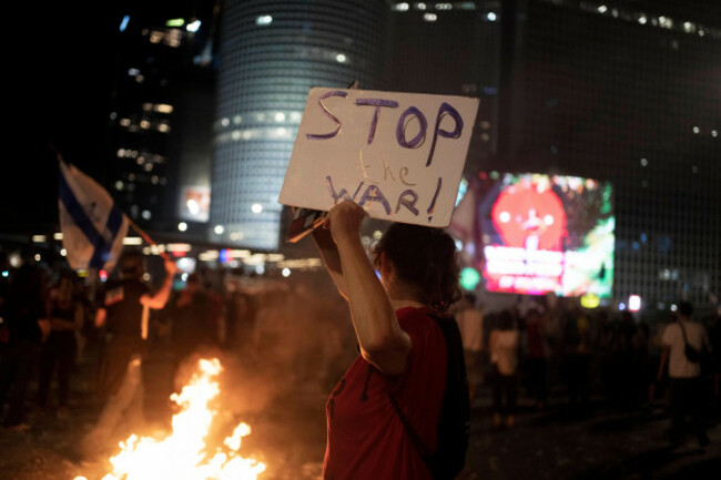 a-protester-stands-beside-a-bonfire-at-a-demonstration-against-israeli-prime-minister-benjamin-netanyahus-government-as-protesters-call-for-the-release-of-hostages-held-in-the-gaza-strip-by-the-hamas