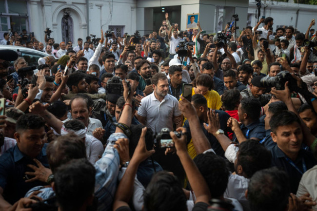 supporters-of-congress-party-cheer-the-party-leader-rahul-gandhi-center-as-he-leaves-the-party-headquarters-after-addressing-a-press-conference-in-new-delhi-india-tuesday-june-4-2024-ap-photo