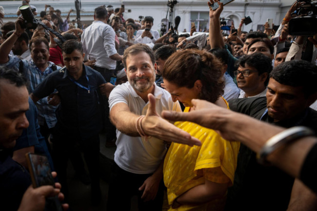 congress-party-leader-rahul-gandhi-center-extends-his-arm-to-greet-a-supporter-as-he-leaves-with-his-sister-and-party-leader-priyanka-gandhi-vadra-after-addressing-a-press-conference-at-the-party-he