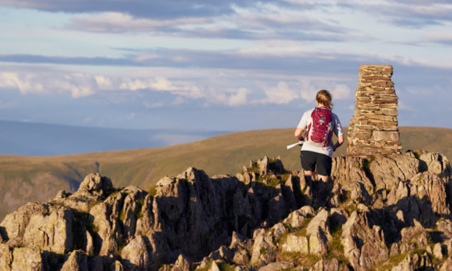 lake-district-england-uk-july-30-2016-a-fell-runner-reaching-the-summit-of-place-fell-at-sunset-english-lake-district-uk