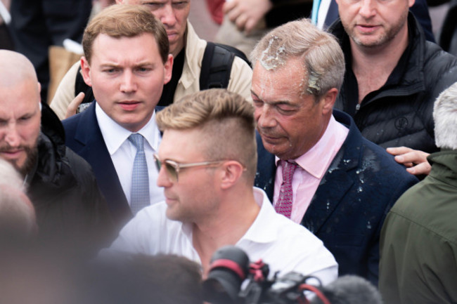 leader-of-reform-uk-nigel-farage-has-a-milkshake-thrown-over-him-as-he-leaves-the-moon-and-starfish-pub-after-launching-his-general-election-campaign-in-clacton-on-sea-essex-picture-date-tuesday-ju