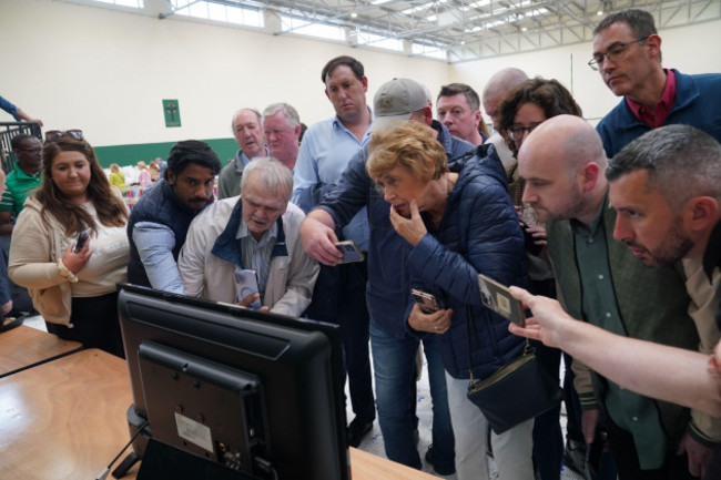people-looking-at-a-television-which-of-showing-the-tally-of-ballots-at-nemo-rangers-gaa-club-during-counting-for-local-and-european-elections-in-cork-ireland-picture-date-saturday-june-8-2024