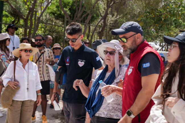 a-tourist-is-carried-by-first-aid-personnel-from-ancient-acropolis-site-in-central-athens-wednesday-june-12-2024-the-ancient-acropolis-site-was-closed-to-the-public-for-five-hours-due-to-a-heat-w