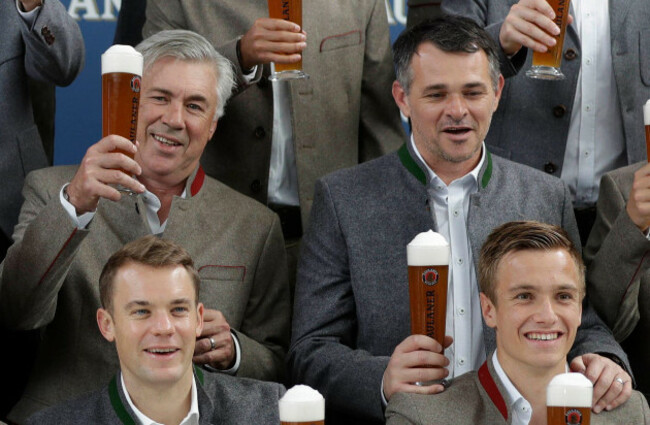 file-in-this-sept-13-2017-file-photo-bayern-coach-carlo-ancelotti-left-and-assistant-willy-sagnol-right-pose-with-beer-in-traditional-bavarian-clothes-during-a-photo-shooting-of-a-brewing-comp