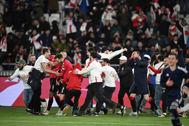 georgias-players-at-team-members-celebrate-after-winning-a-penalty-shootout-at-the-end-of-the-euro-2024-qualifying-play-off-soccer-match-between-georgia-and-greece-at-the-boris-paichadze-national-sta