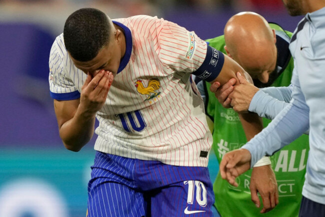 kylian-mbappe-of-france-holds-his-nose-after-suffering-an-injury-during-a-group-d-match-between-austria-and-france-at-the-euro-2024-soccer-tournament-in-duesseldorf-germany-monday-june-17-2024-a