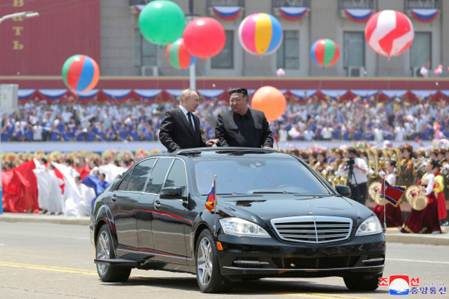 in-this-photo-provided-thursday-june-20-2024-by-the-north-korean-government-russian-president-vladimir-putin-center-left-and-north-koreas-leader-kim-jong-un-center-right-ride-on-an-open-car