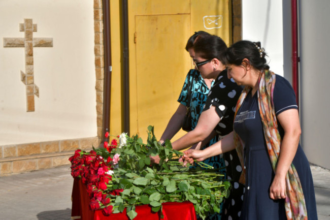 women-lay-flowers-at-a-makeshift-memorial-in-front-of-the-holy-assumption-cathedral-after-an-attack-by-islamic-militants-in-makhachkala-republic-of-dagestan-russia-monday-june-24-2024-the-attack