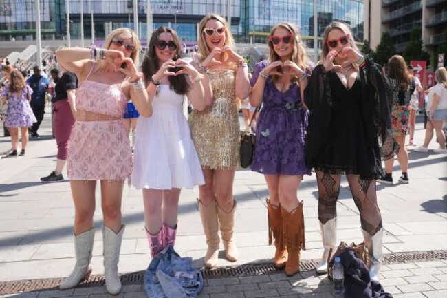 a-group-of-fans-pose-for-a-photo-outside-wembley-stadium-in-london-ahead-of-taylor-swifts-first-london-concert-during-her-eras-tour-picture-date-friday-june-21-2024