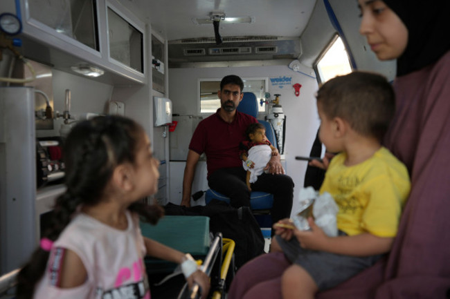 palestinian-children-with-chronic-diseases-sit-with-their-relatives-before-they-leave-the-gaza-strip-for-treatment-abroad-through-the-kerem-shalom-crossing-in-khan-younis-southern-gaza-strip-thursd
