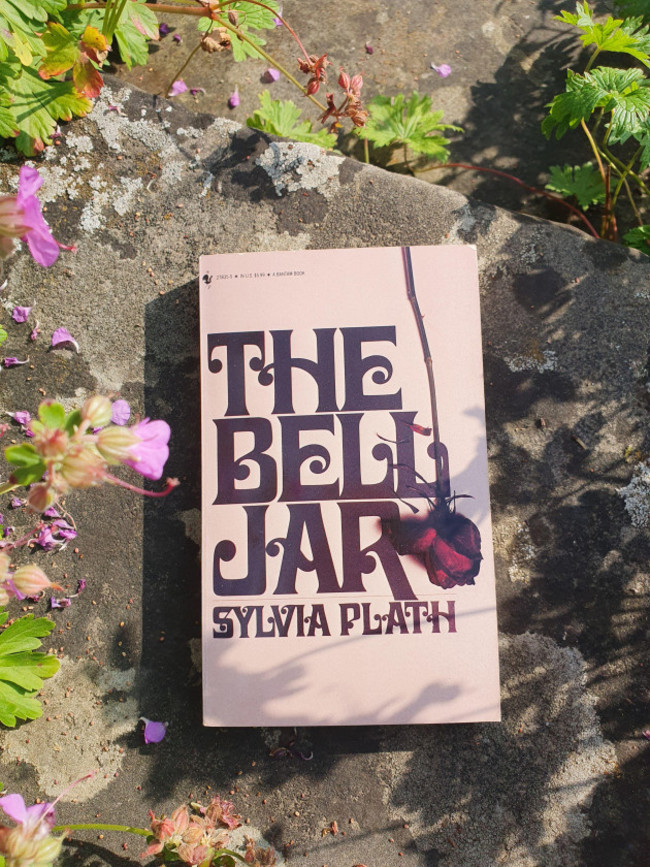 the-bell-jar-novel-by-sylvia-plath-book-in-a-garden-scenery
