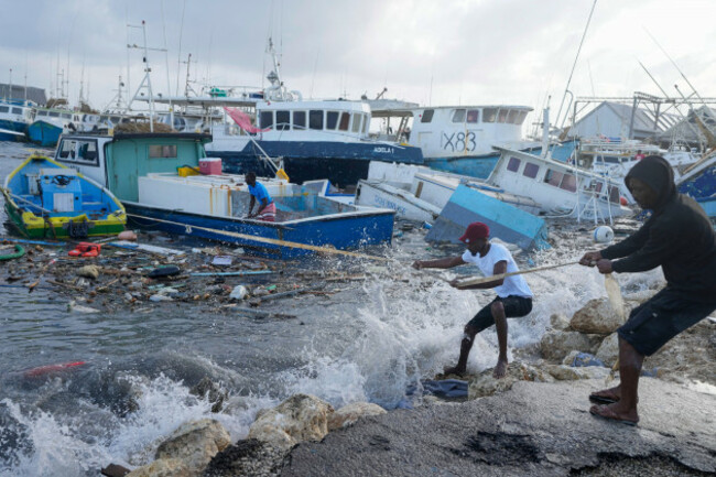 fishermen-pull-a-boat-damaged-by-hurricane-beryl-back-to-the-dock-at-the-bridgetown-fisheries-in-barbados-monday-july-1-2024-ap-photoricardo-mazalan